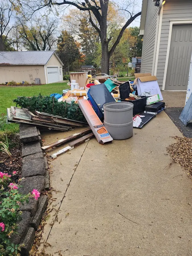 Dumpster being loaded with debris for Roofing Dumpster Rental in Taylor